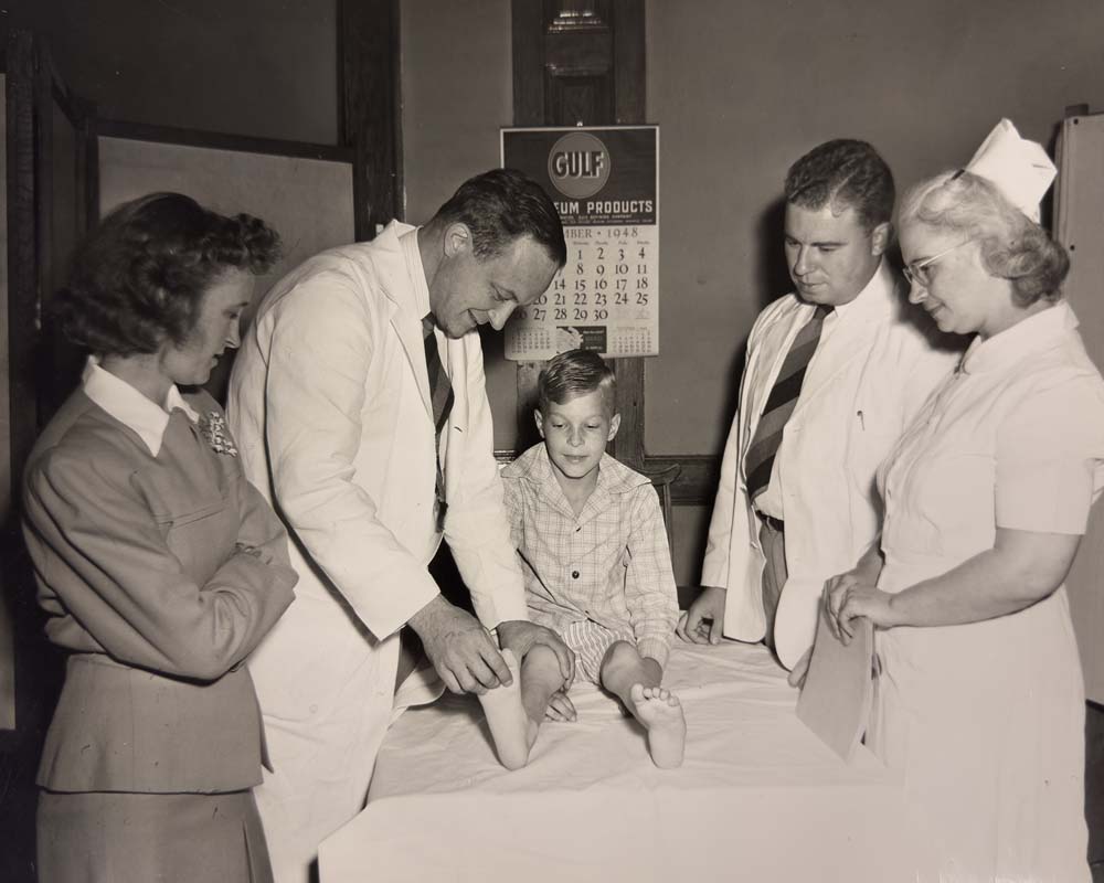 Chief Dr. George Hammond and Dr. Willard E. Dotter with a patient at the Bradford County Crippled Children’s Clinic in Towanda, 1948.