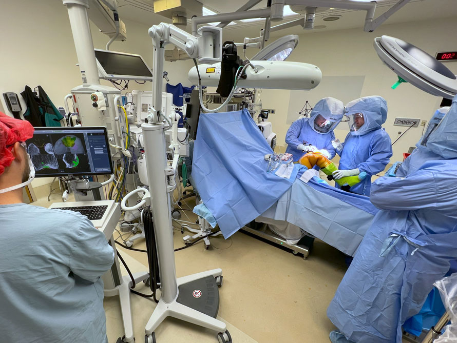 Medical team performs surgery on a patient's leg